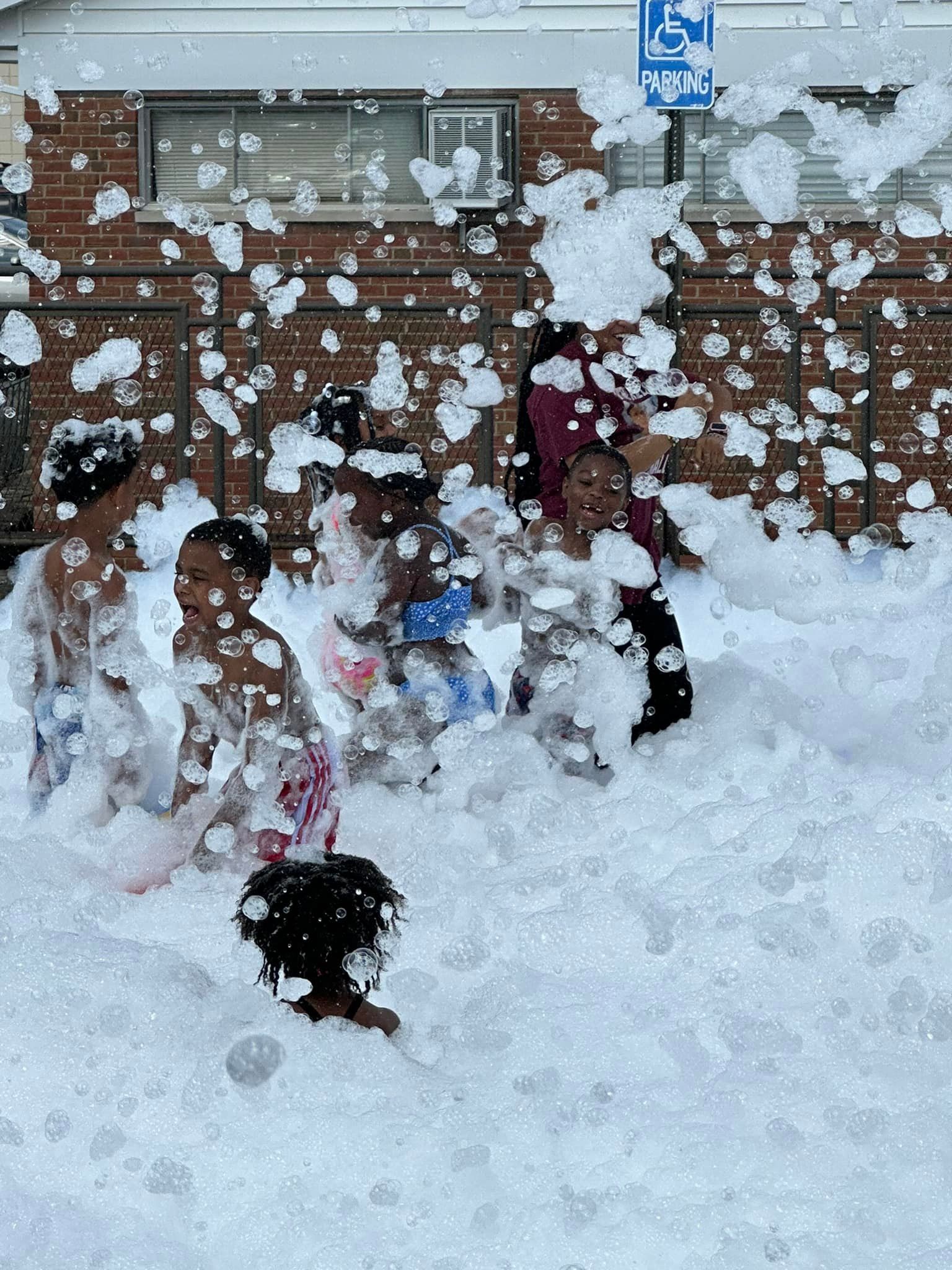 A group of children are playing in a pool of foam.
