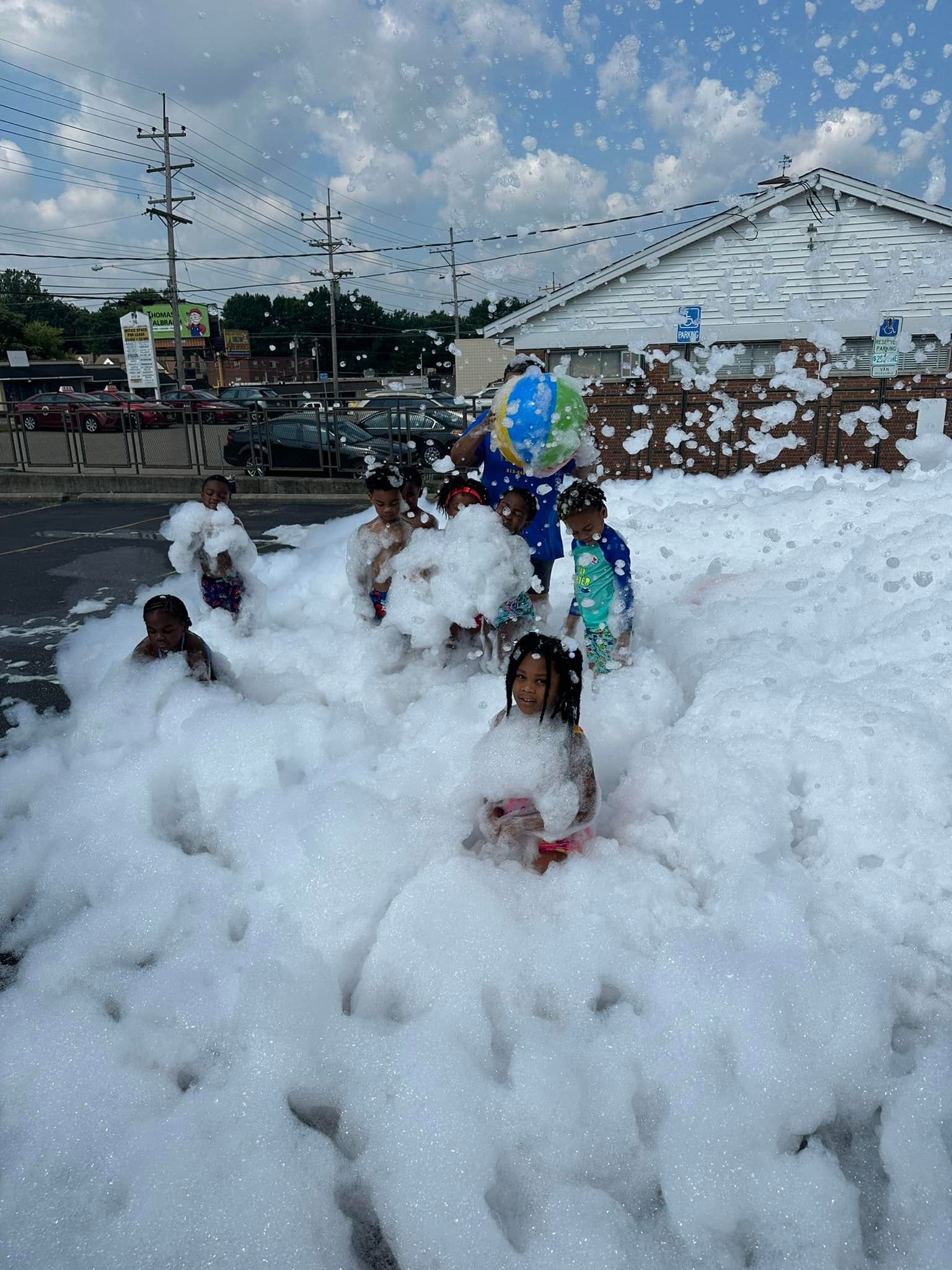 A group of children are playing in a pile of foam.