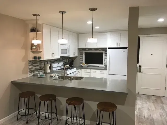 A kitchen with a large counter and stools