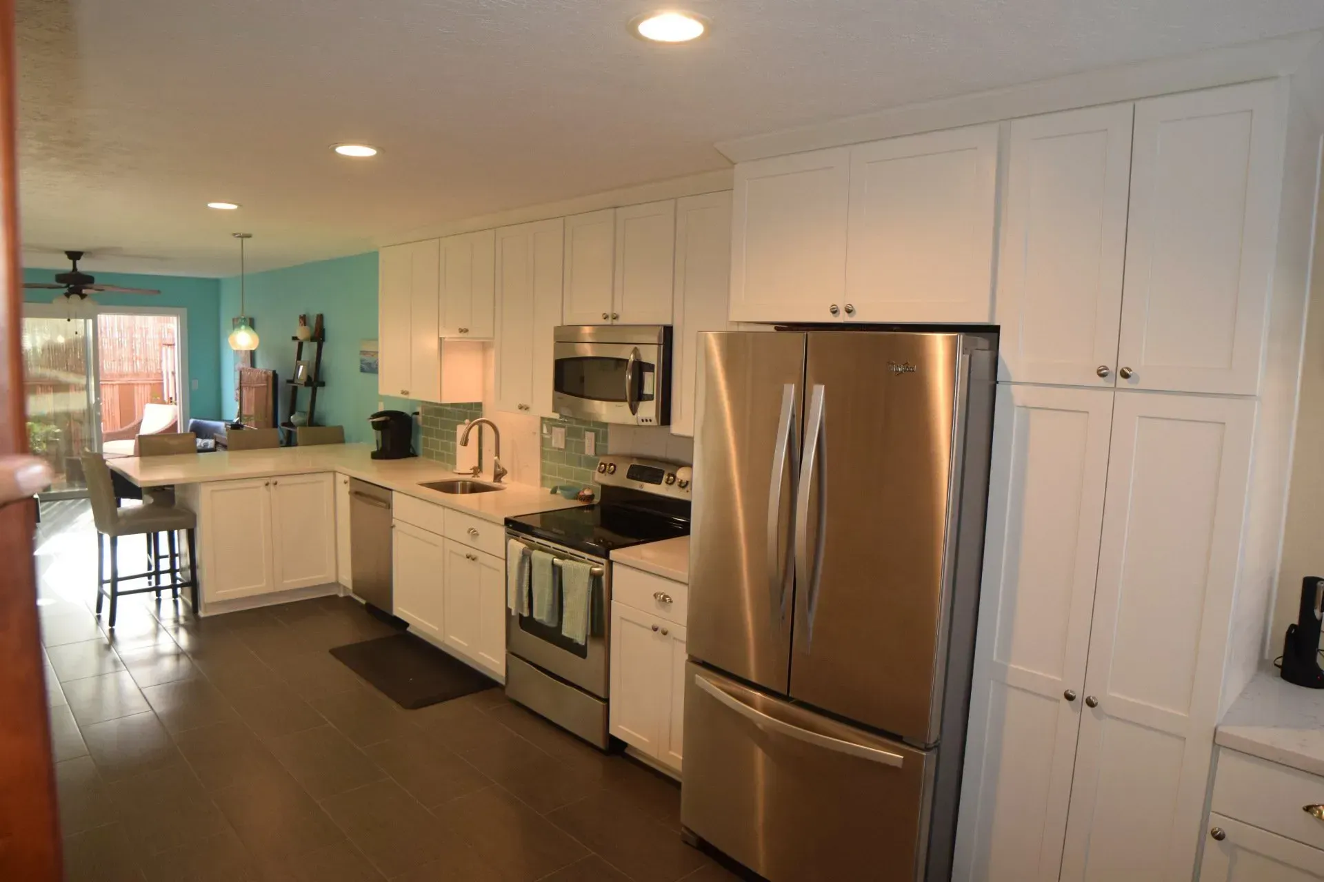 A kitchen with stainless steel appliances and white cabinets