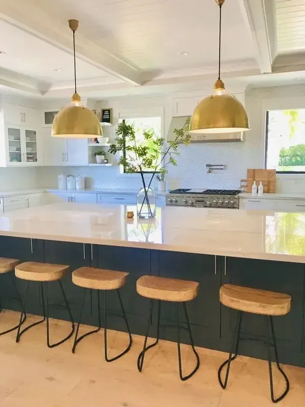 A kitchen with a large island and stools