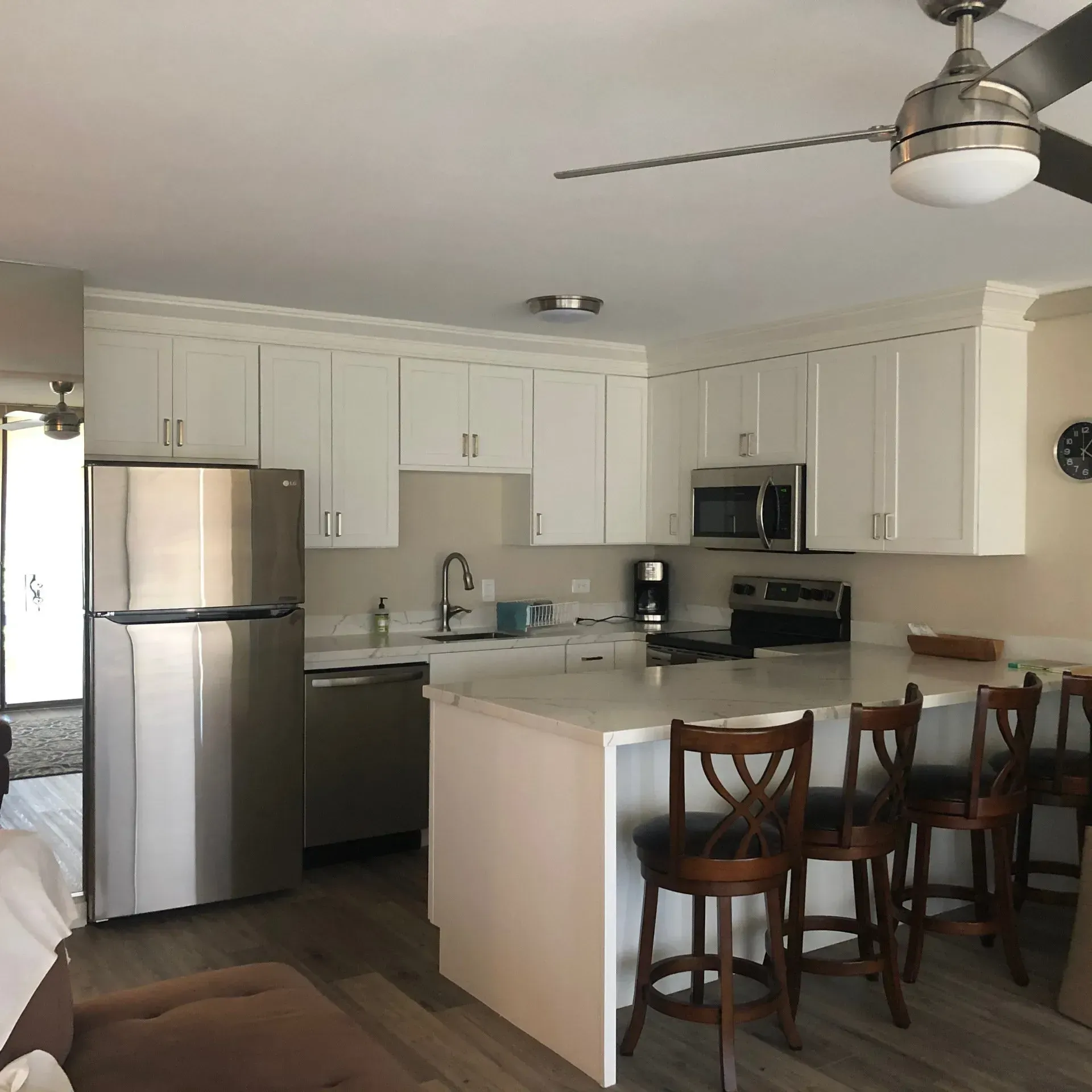 A kitchen with stainless steel appliances and white cabinets