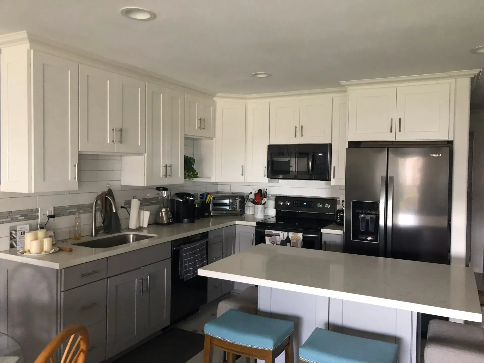 A kitchen with white cabinets and stainless steel appliances