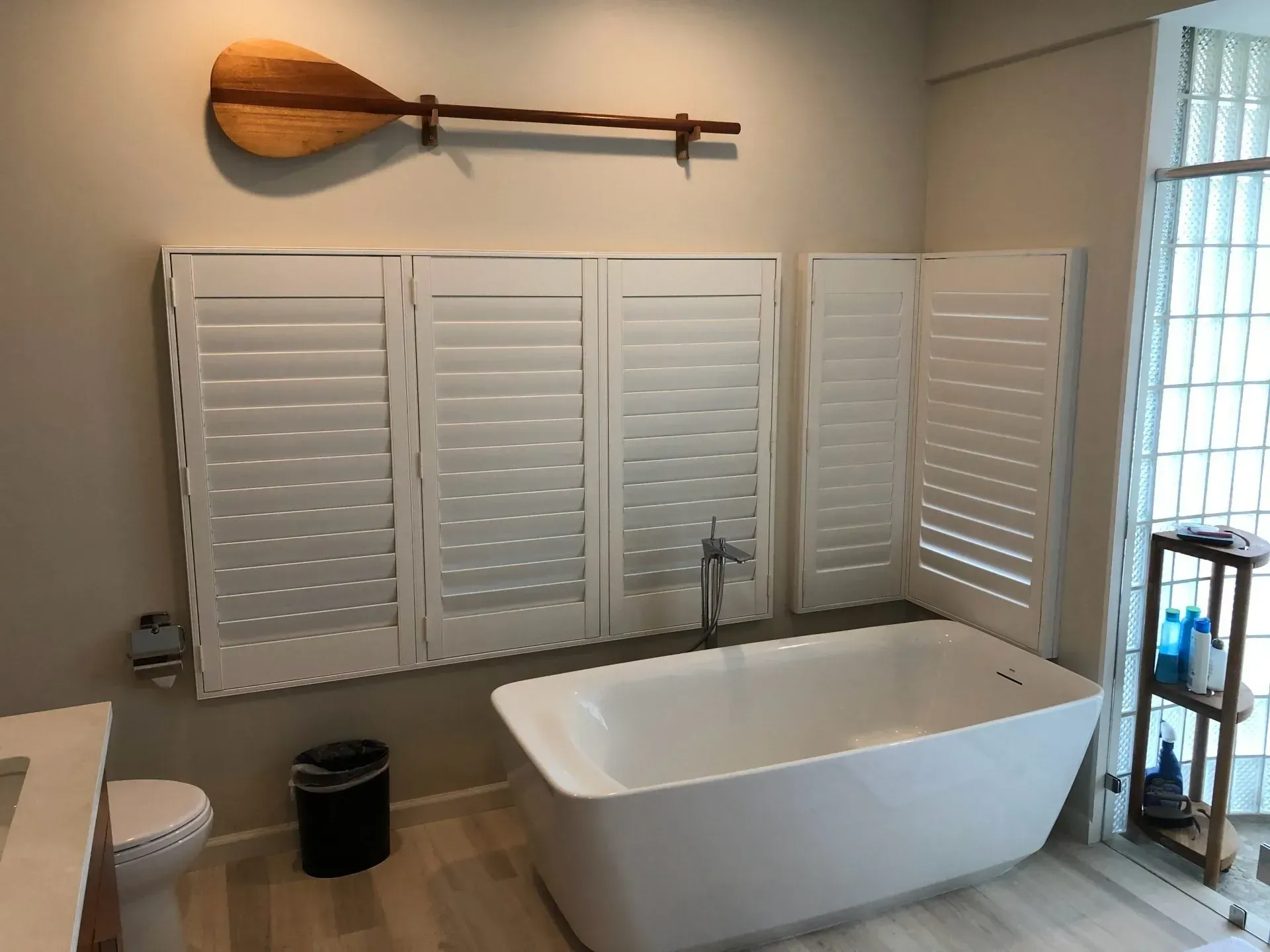 A hallway with stairs and cabinets underneath them.
