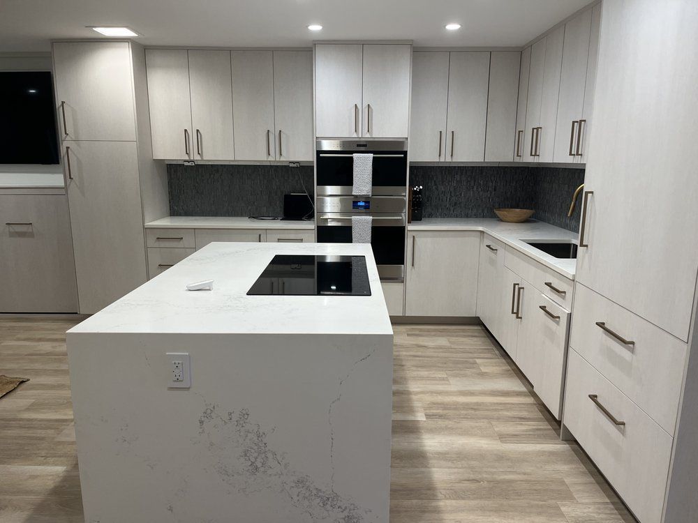 A hallway with stairs and cabinets underneath them.