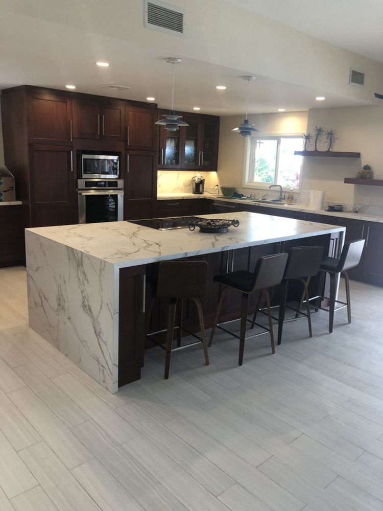 A hallway with stairs and cabinets underneath them.