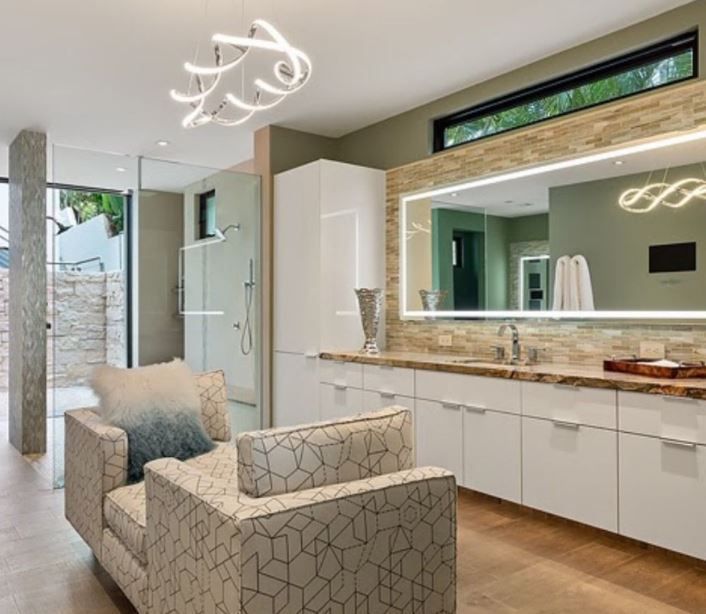 A hallway with stairs and cabinets underneath them.