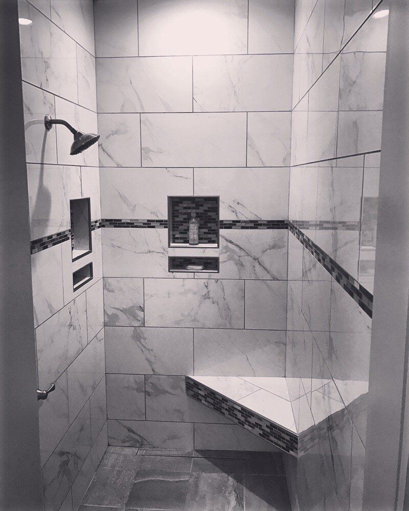 A hallway with stairs and cabinets underneath them.