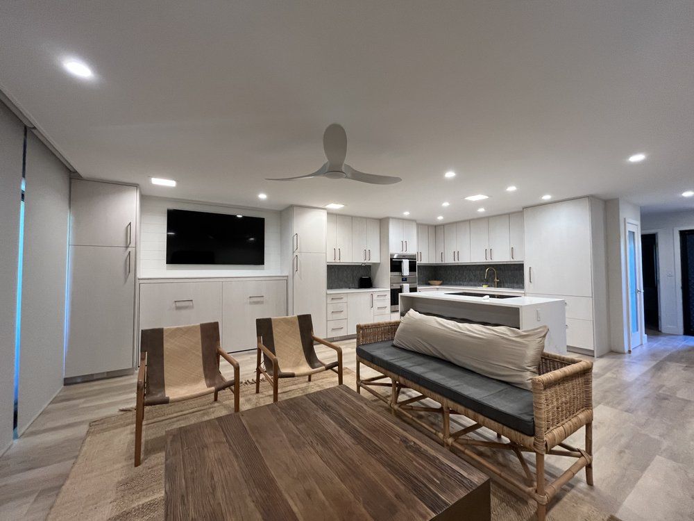 A hallway with stairs and cabinets underneath them.