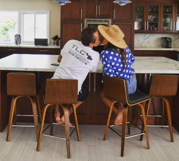 A group of people are looking at a blueprint of a house.
