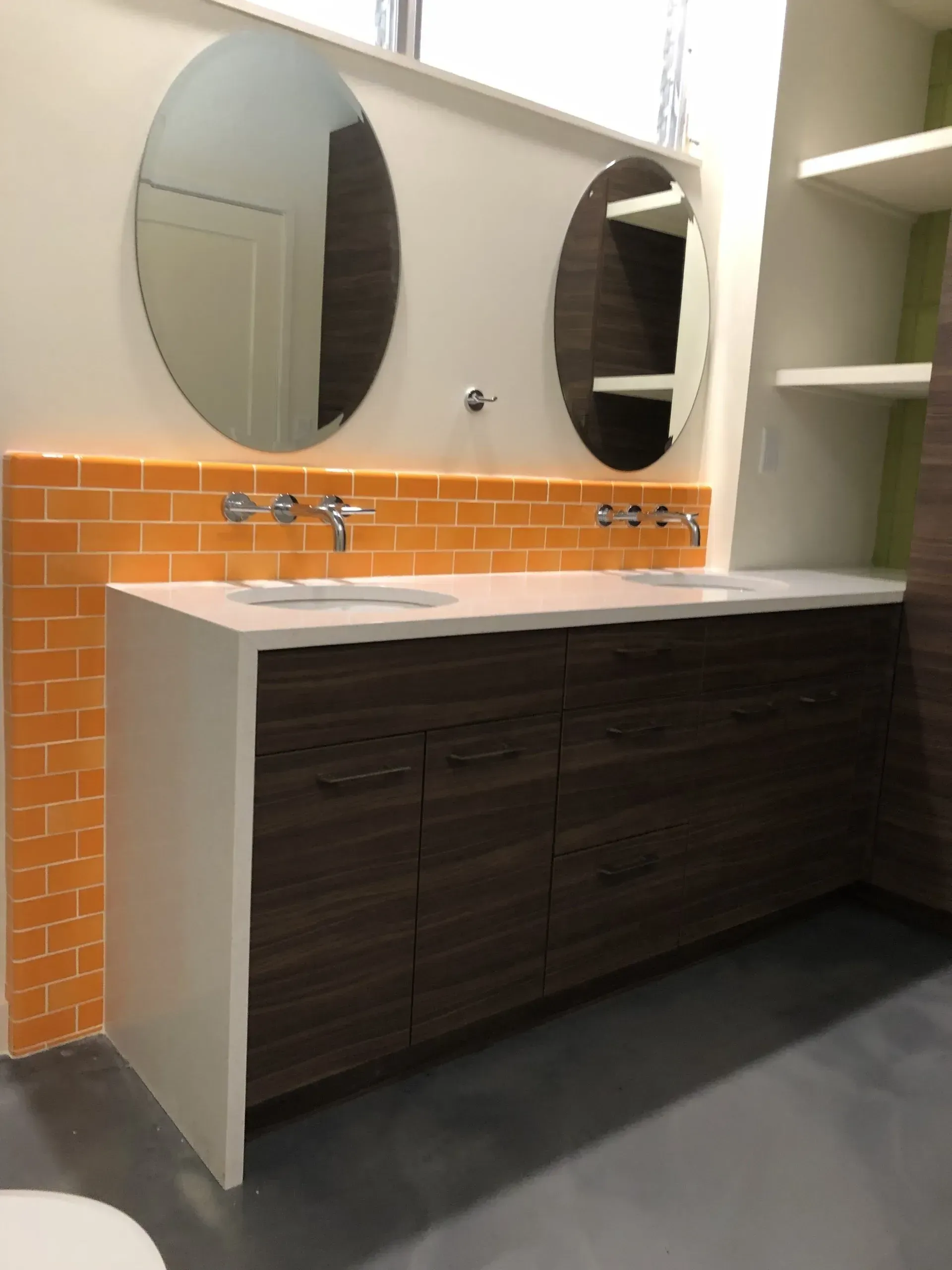 A bathroom with two sinks and two mirrors