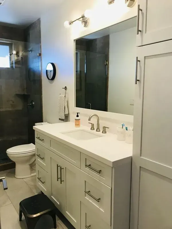 A bathroom with a sink , toilet , and mirror.