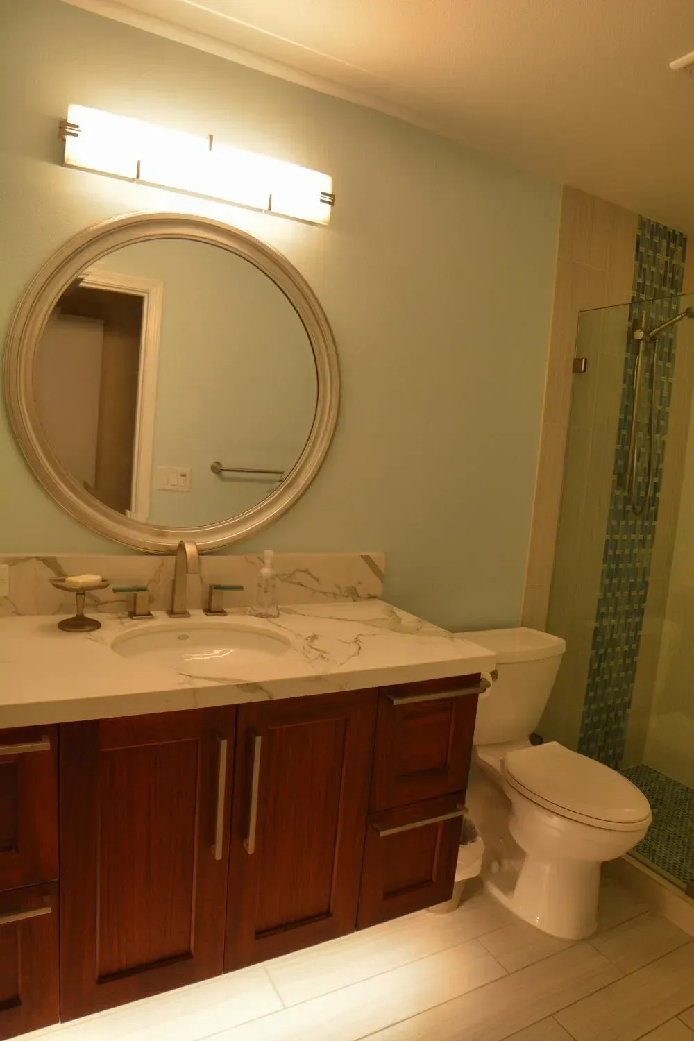 A bathroom with a sink , toilet and mirror