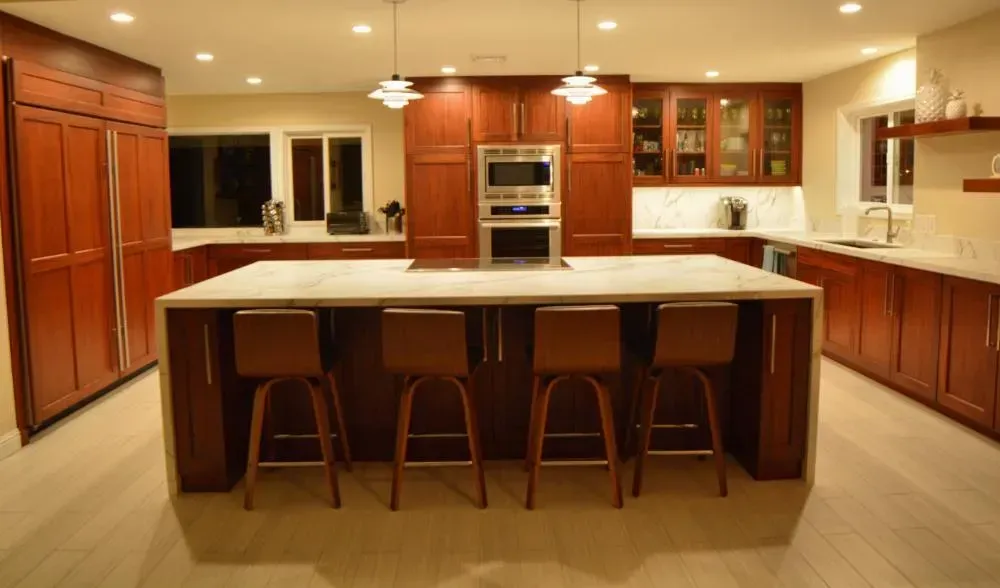 A kitchen with a large island and stools