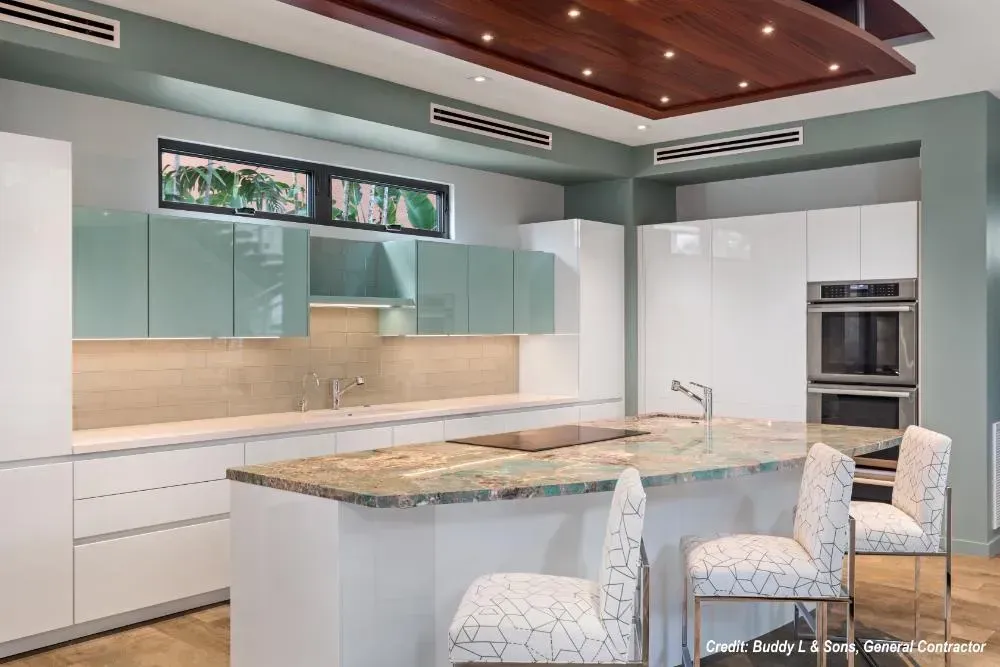 A kitchen with white cabinets , granite counter tops , and stainless steel appliances.