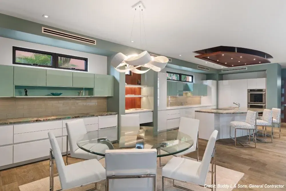 A kitchen with a glass table and chairs in it