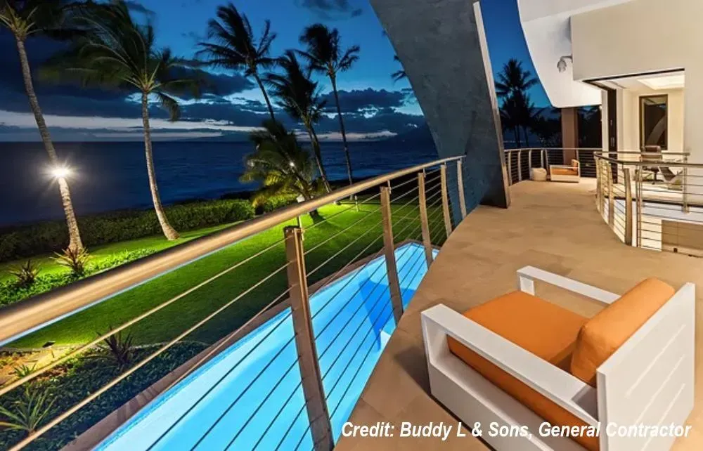 A picture of a balcony with a chair and a pool taken by credit buddy & sons general contracting