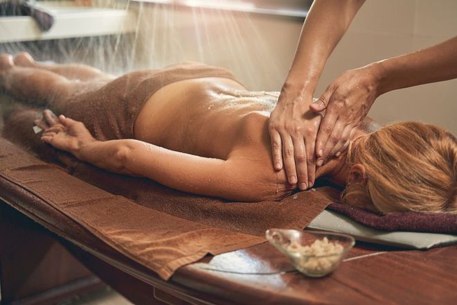 A woman is getting a massage in a spa.