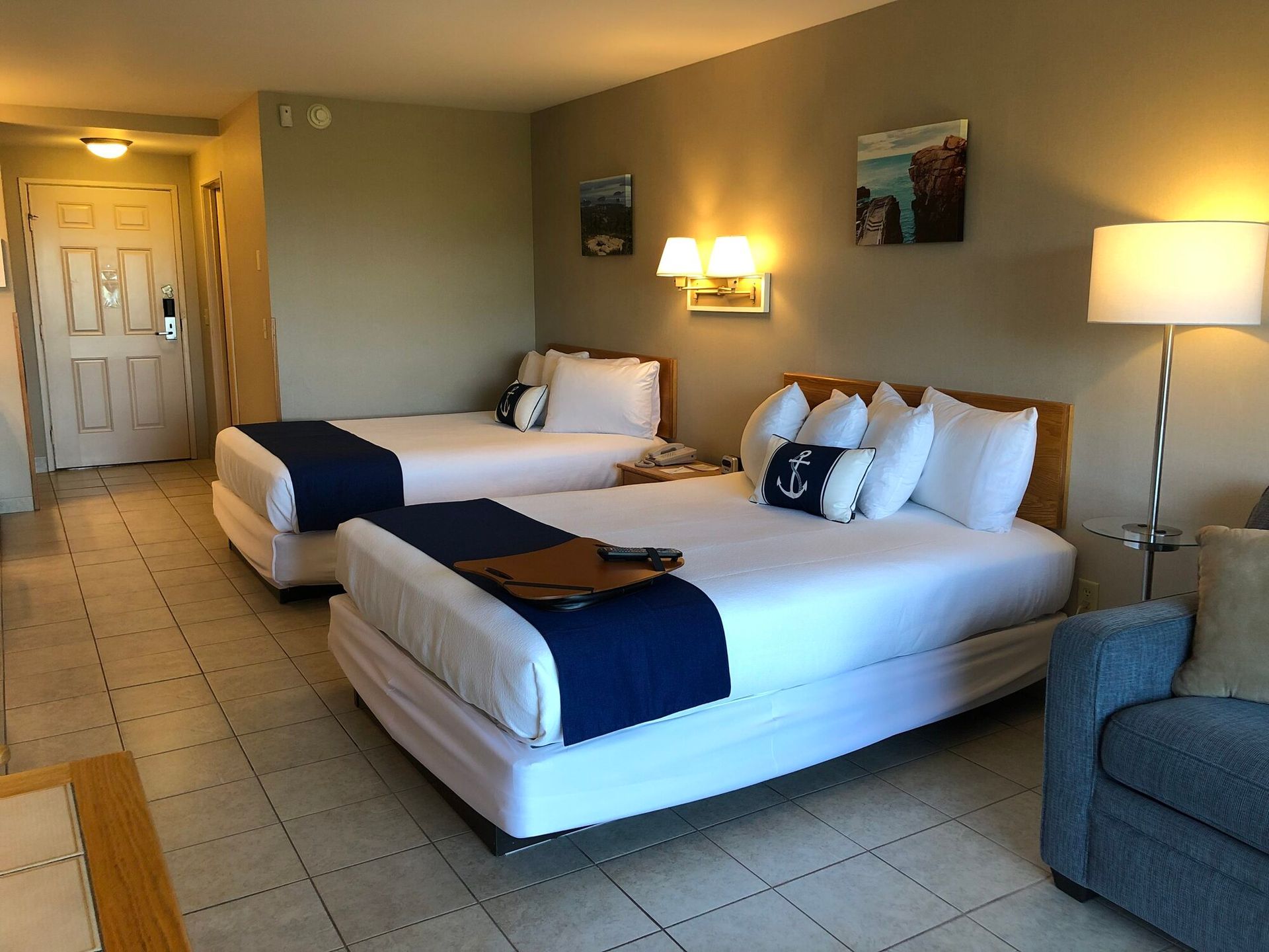 A hotel room with two beds and a couch