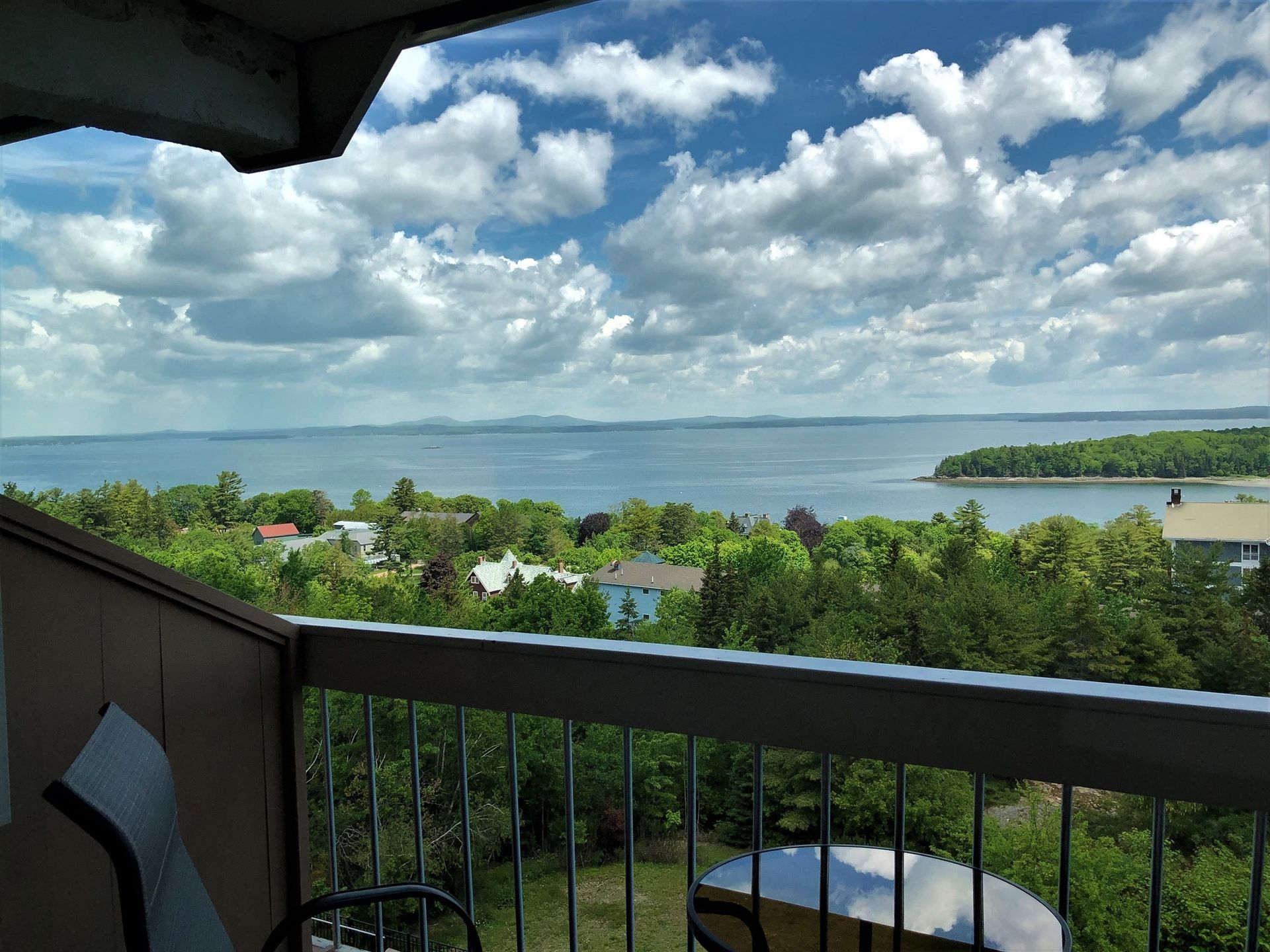 A balcony with a view of a body of water