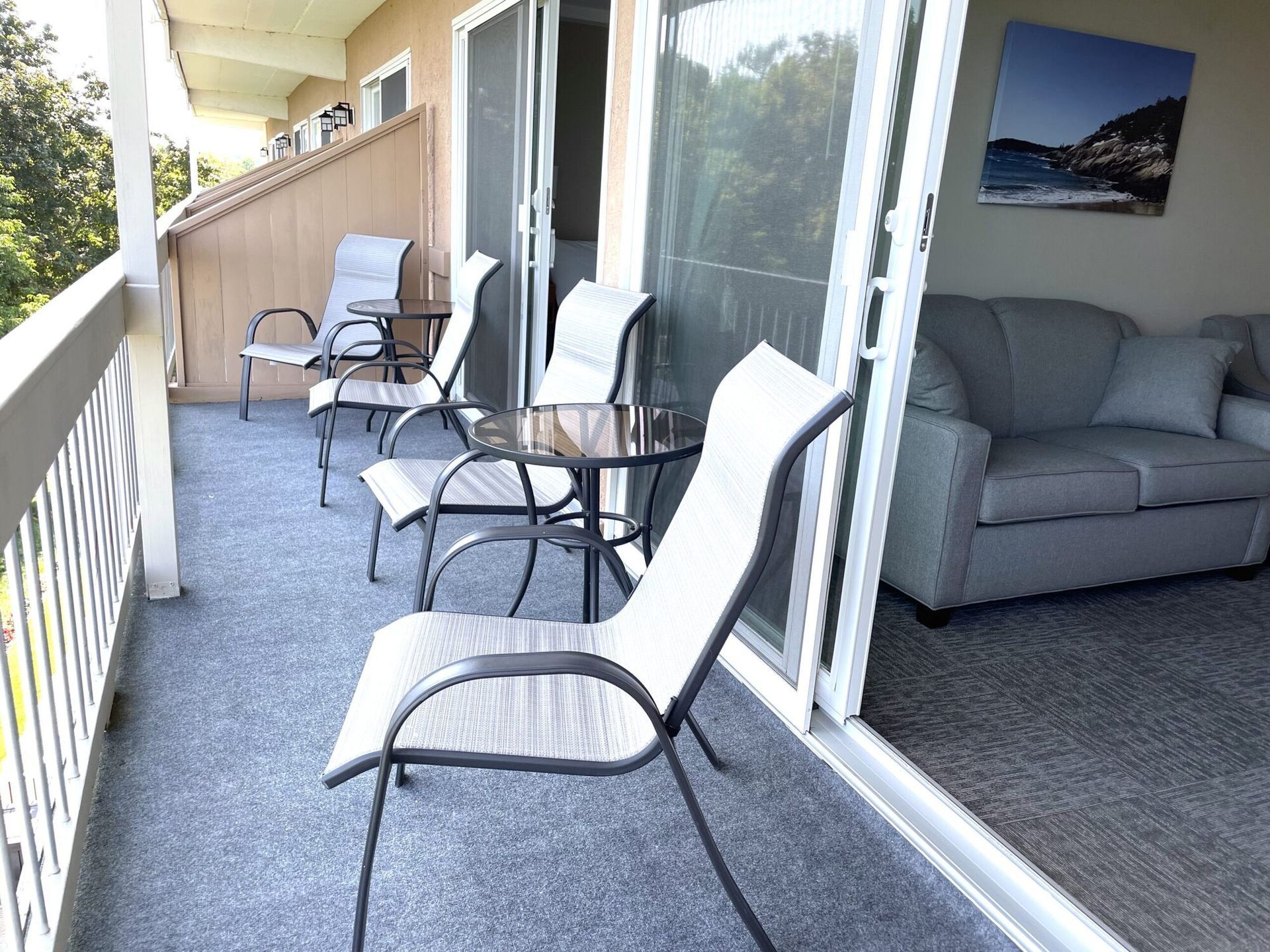 A balcony with chairs a table and a couch
