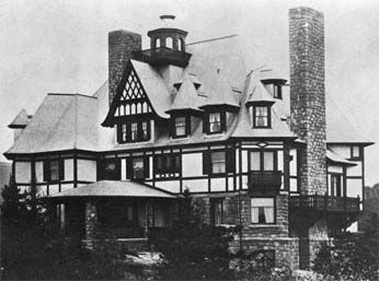 A black and white photo of a large house