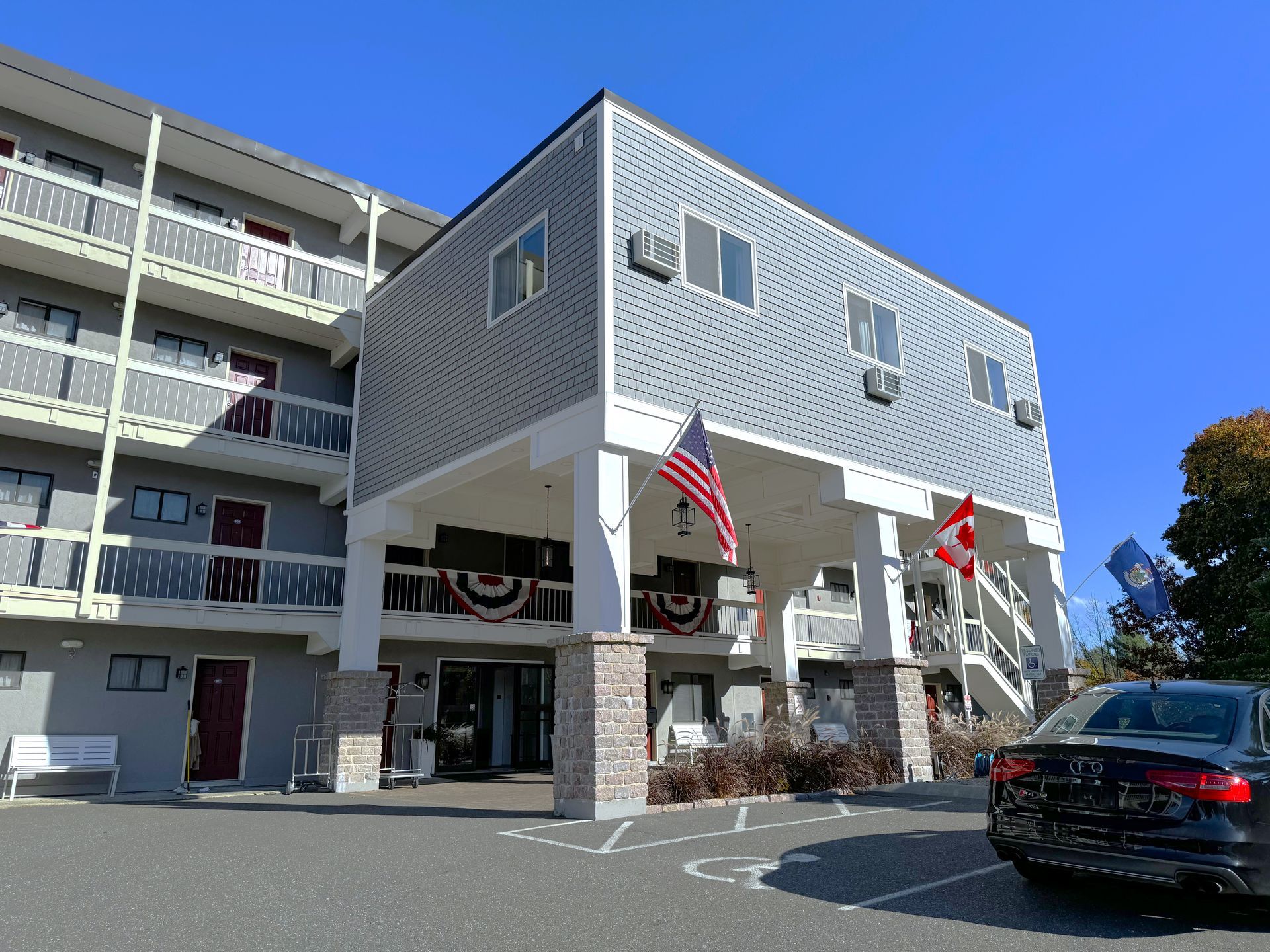 A large building with a car parked in front of it