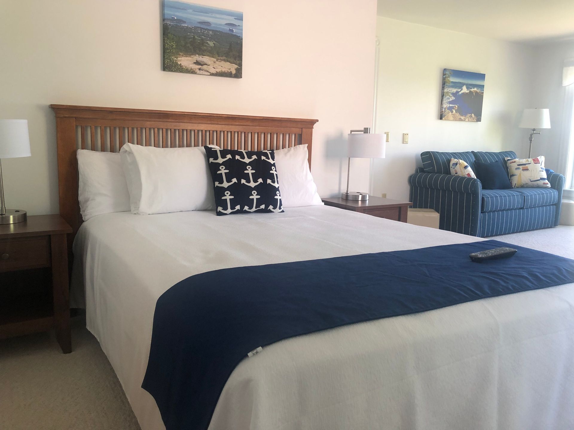 A bedroom with a bed and a blue couch