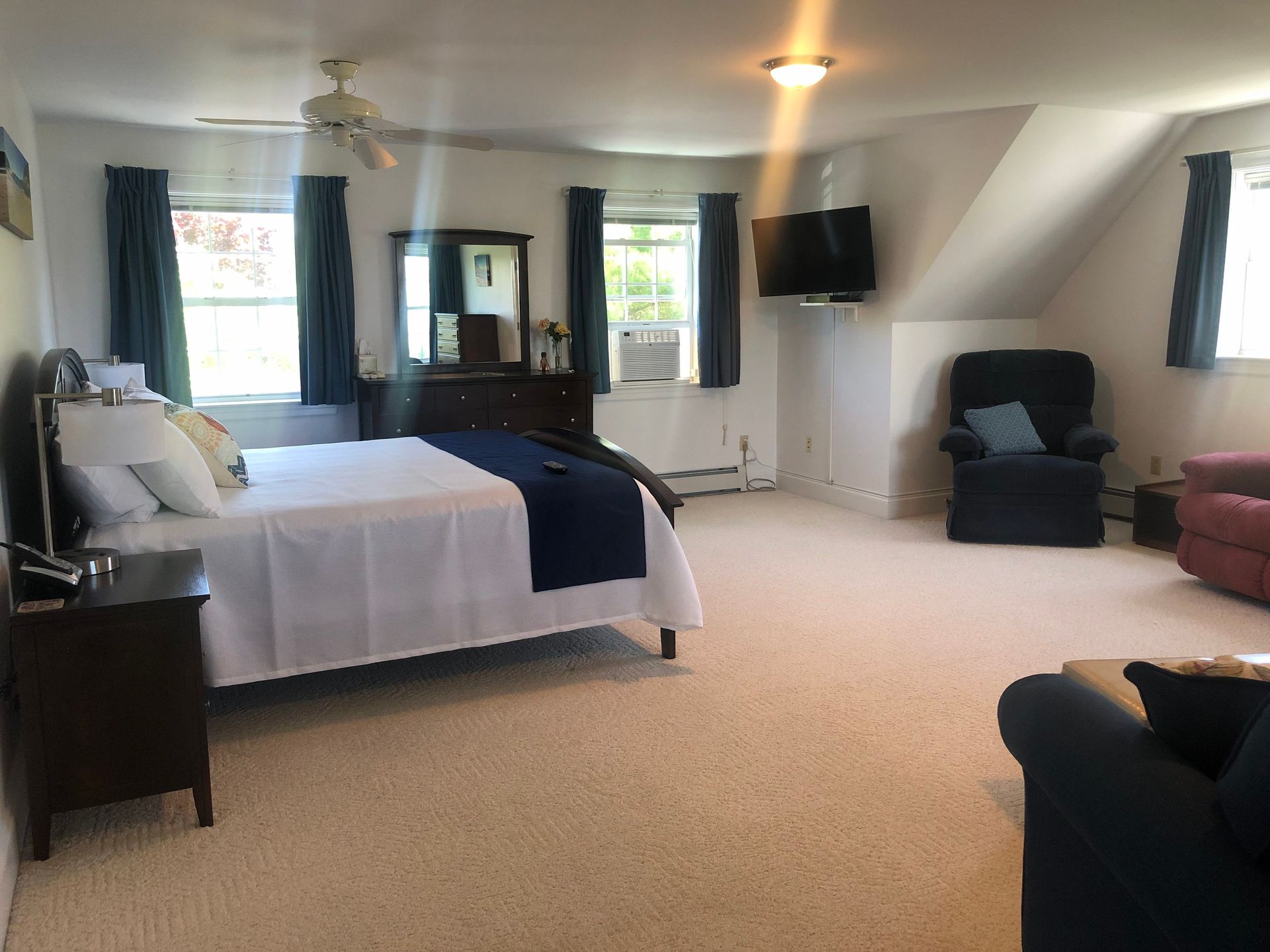 A large bedroom with a king size bed and a living room