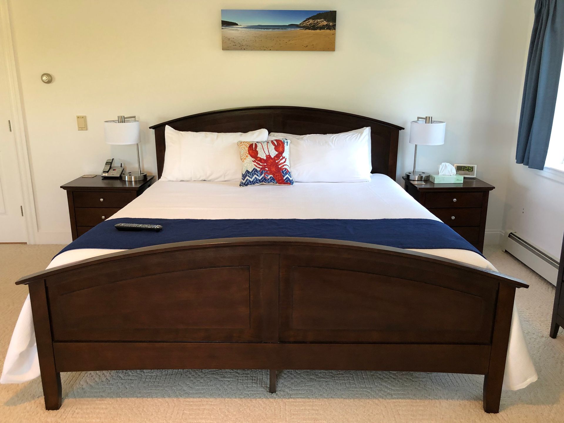 A bedroom with a king size bed and two nightstands