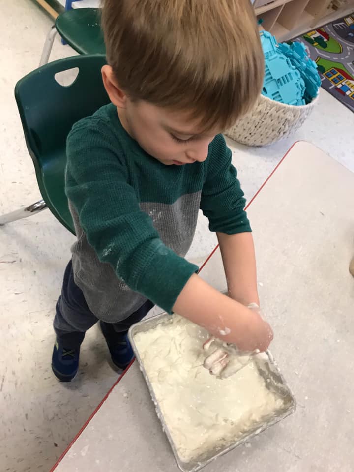 Kid Playing Small Statue Animals — Potomac, MD — Little Acorns Early Learning Center