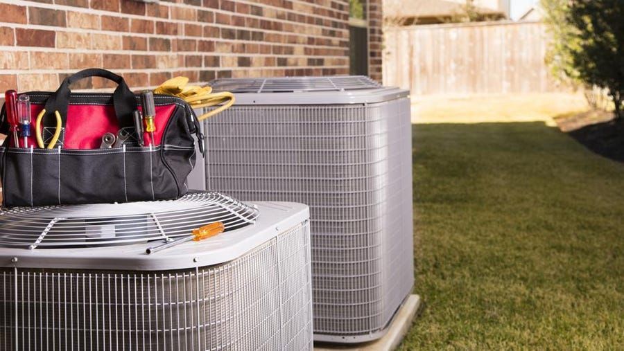 Tool bag on top of AC unit outside of home