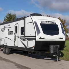A connect trailer is parked on the side of the road