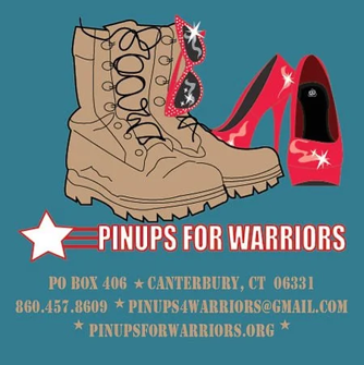 Four women pose on a rocky mountaintop. They wear workout clothes and smile, with mountains in the background.