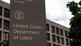 A sign for the united states department of labor is in front of a building.