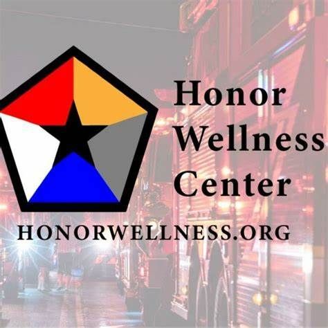 A logo for honor wellness center with a fire truck in the background