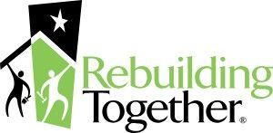 A logo for rebuilding together with a house and people holding a flag.