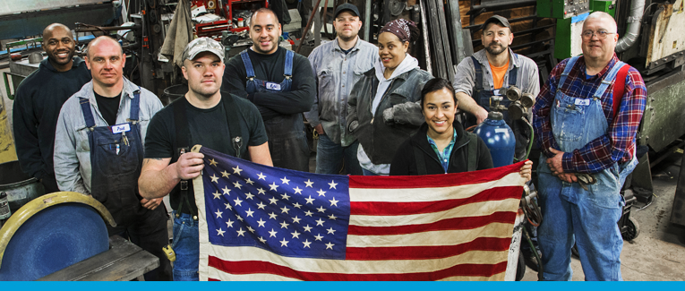 A group of people standing next to each other holding an american flag.