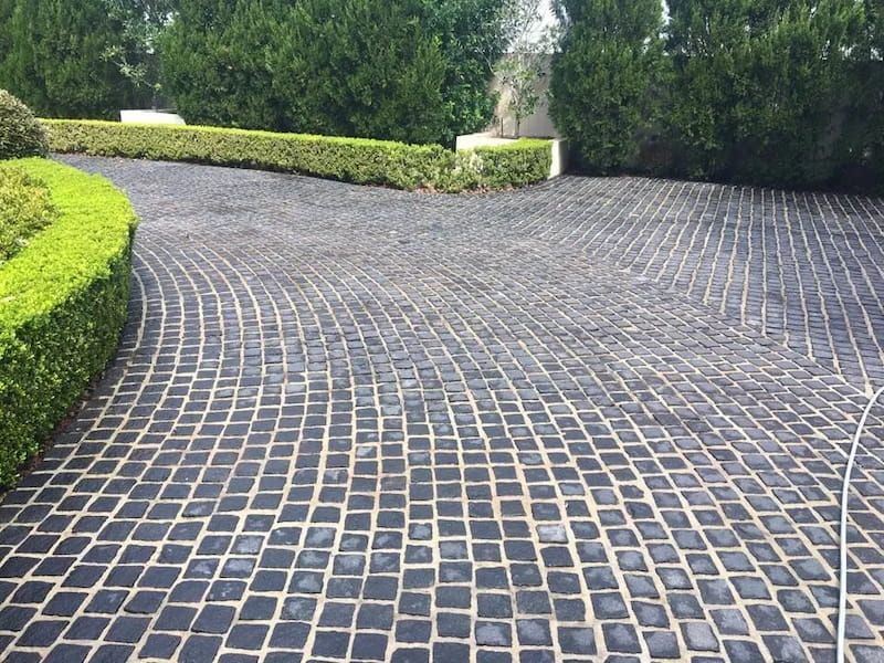 Driveway With Black Cobblestones and Bushes — Excess Cleaning in North West Coast Tasmania, TAS