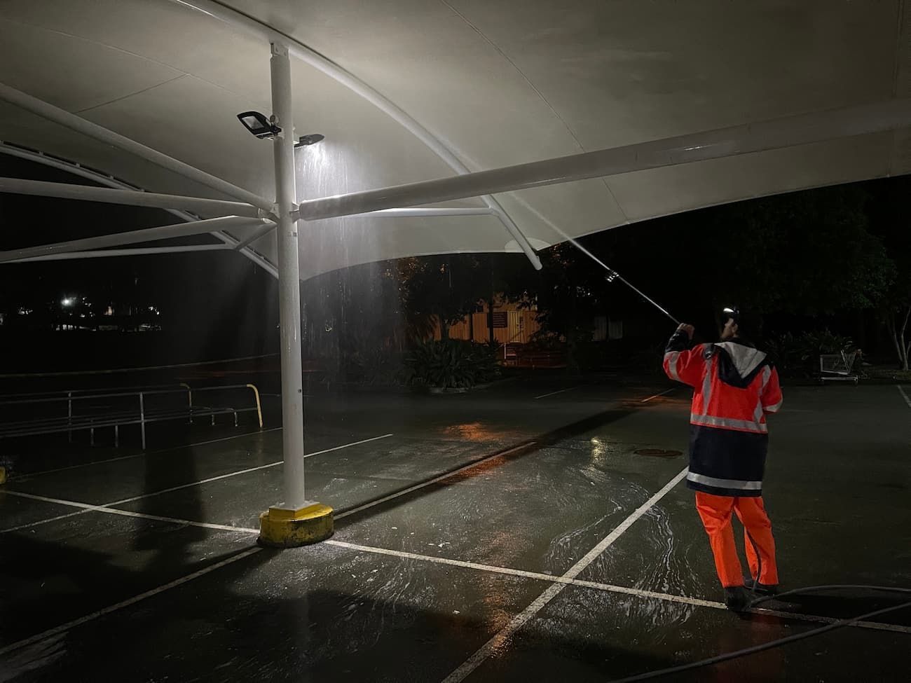 Man Cleaning Parking Lot at Night — Excess Cleaning in Molendinar, QLD