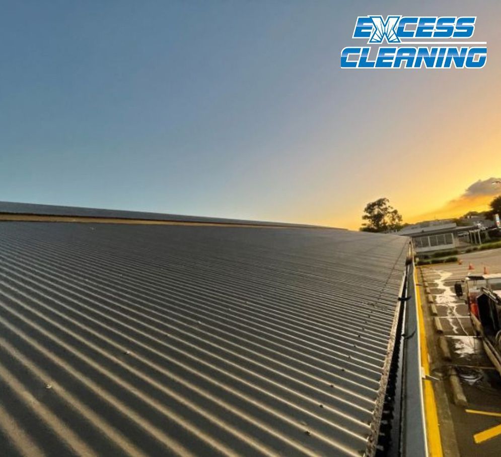 The Roof Of A Building Is Being Cleaned By Excess Cleaning — Excess Cleaning In Ashmore, QLD