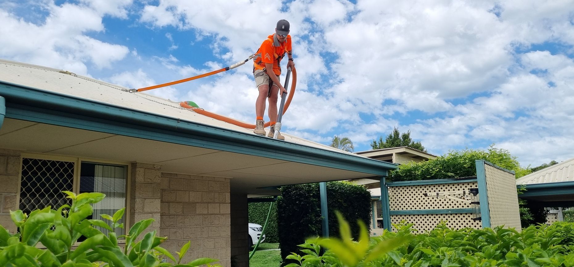 The Corner of a Building With a Blue Sky in the Background — Excess Cleaning in Molendinar, QLD