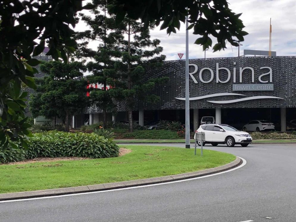 A White Car is Parked in Front of a Robina Store — Excess Cleaning in Robina, QLD