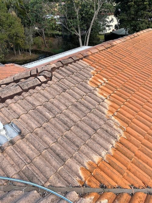 Tiled Roof Being Cleaned With a Hose — Excess Cleaning in Melbourne City, VIC