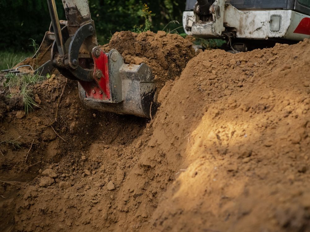 A Bulldozer is Digging a Hole in the Ground — SMH Valley Fencing & Maintenance In Singleton, NSW