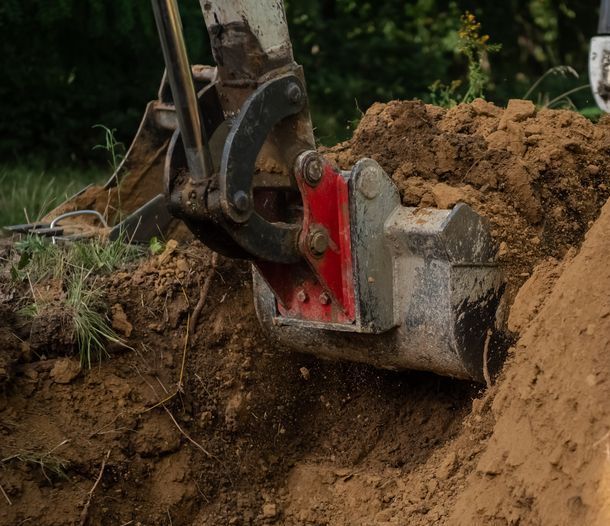 A Bulldozer is Digging a Hole in the Ground — SMH Valley Fencing & Maintenance In Millfield, NSW