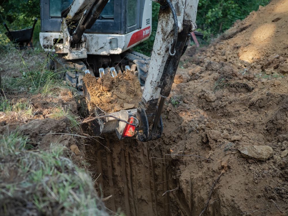 A Bulldozer is Digging a Hole in the Ground — SMH Valley Fencing & Maintenance In Millfield, NSW