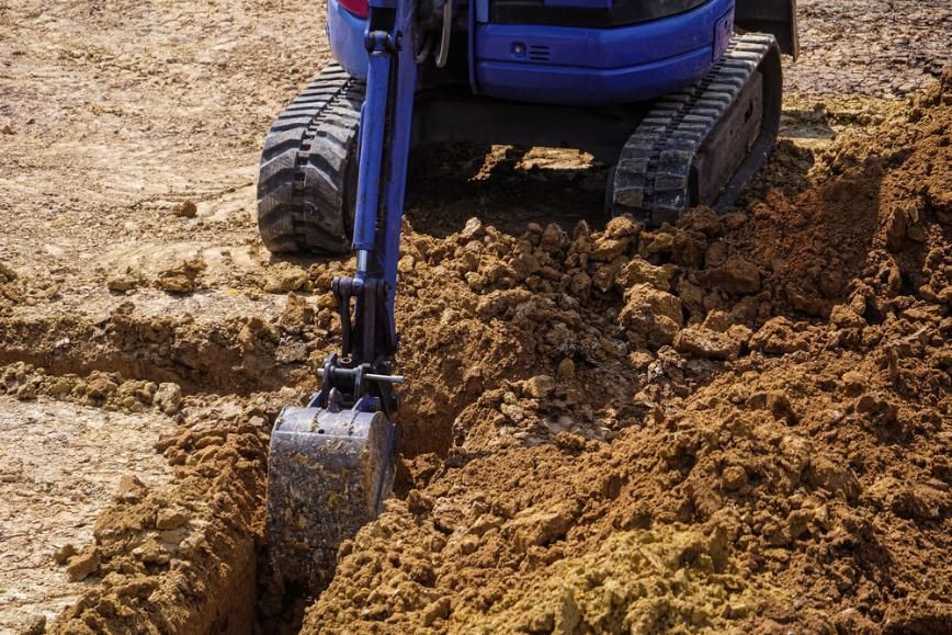 A Blue Truck digging out Mud — SMH Valley Fencing & Maintenance In Millfield, NSW