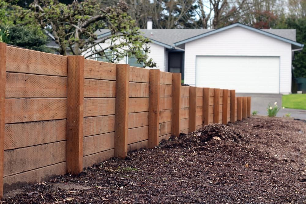A Wooden Fence throughout a garden with house in background — SMH Valley Fencing & Maintenance In Millfield, NSW