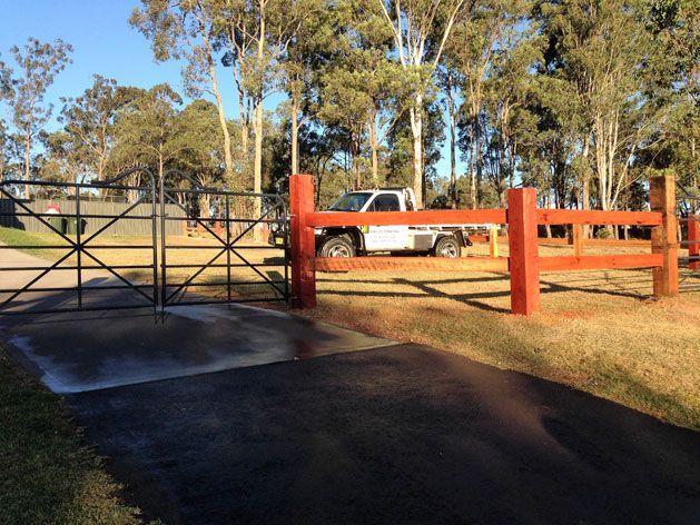 A White Truck is Parked Behind a Red Fence — SMH Valley Fencing & Maintenance In Rutherford, NSW